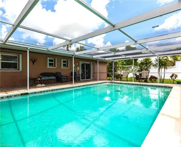 View of swimming pool with a patio and a lanai