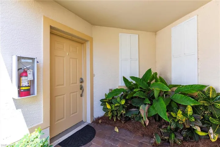 View of exterior entry with stucco siding