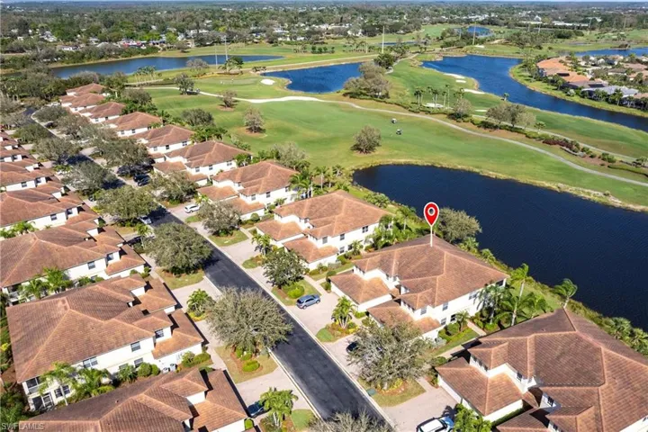 Aerial view of property's location featuring nearby suburban area, a golf club, and a nearby body of water
