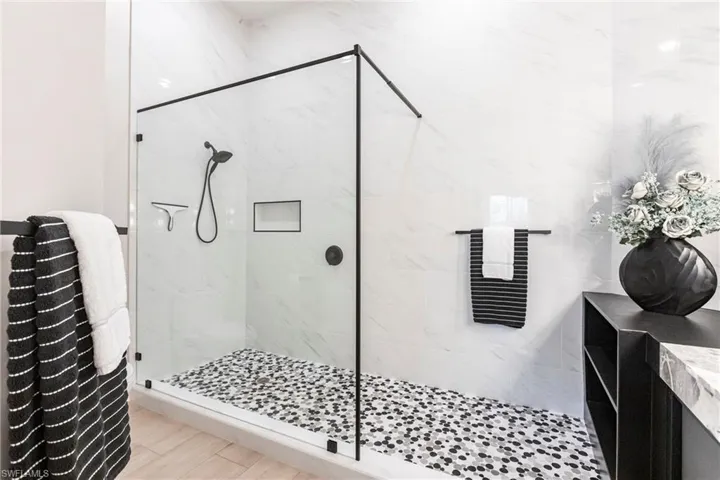 Bathroom featuring a shower stall and vanity