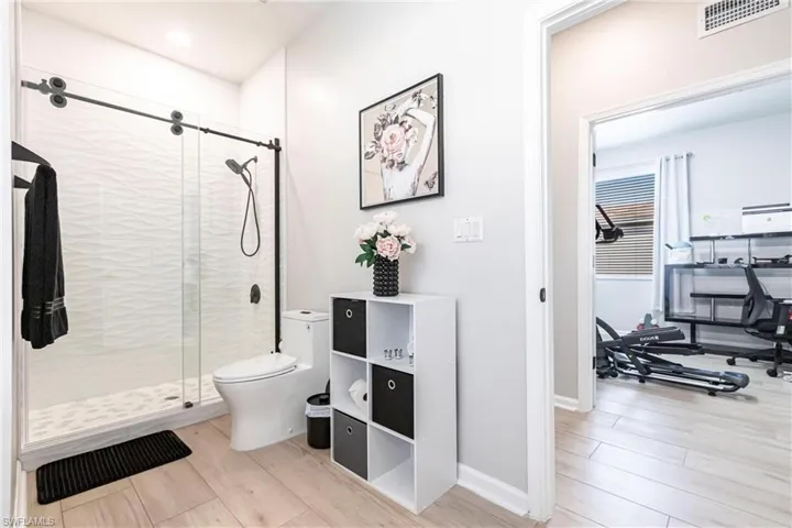 Bathroom featuring a stall shower and light wood-type flooring