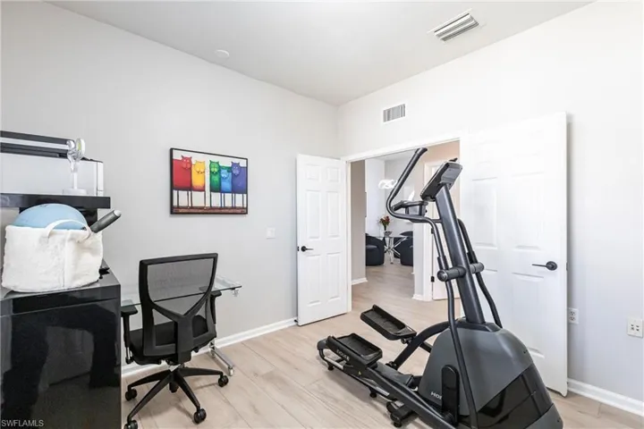 Office space featuring light wood-style floors and baseboards