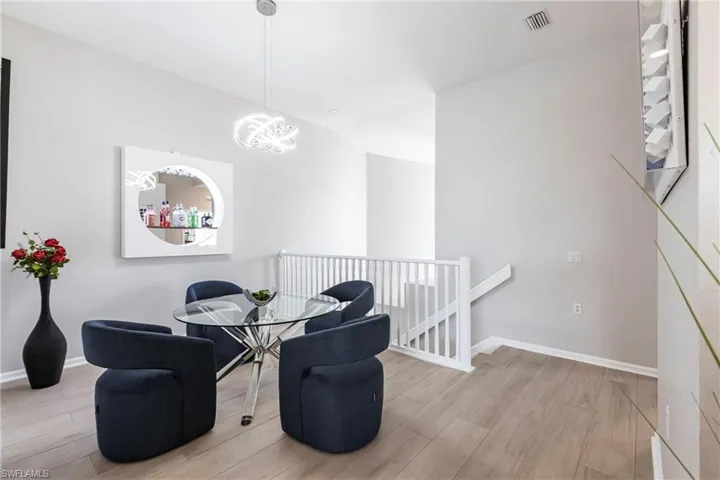 Dining room with light wood finished floors and lofted ceiling