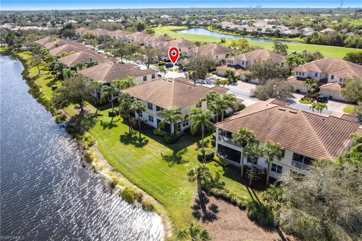 Aerial view of residential area featuring a large body of water