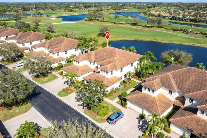 Aerial perspective of suburban area with a local golf course and a large body of water