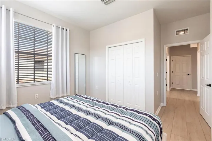 Bedroom with light wood-type flooring and a closet