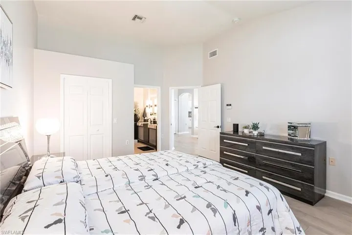 Bedroom with light wood finished floors and a closet
