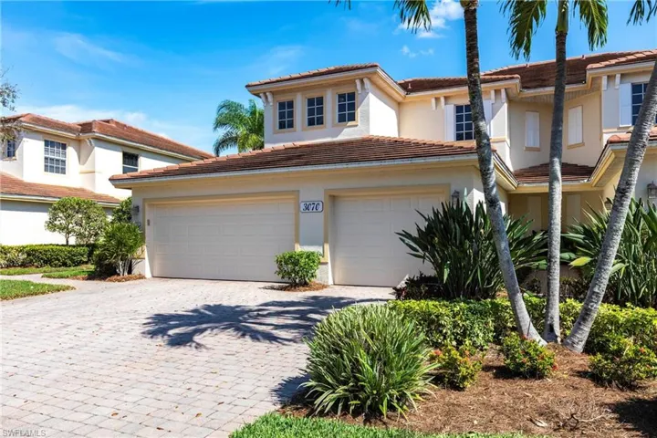 Mediterranean / spanish-style home with decorative driveway, stucco siding, and a tile roof