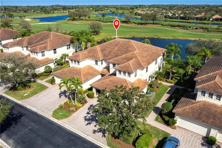Aerial view of residential area with a large body of water and a golf club