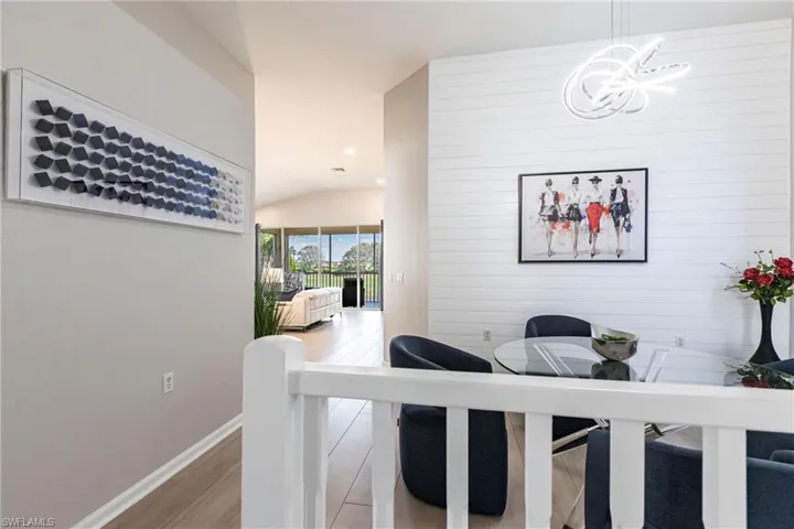 Living area featuring vaulted ceiling, light wood-style flooring, and recessed lighting