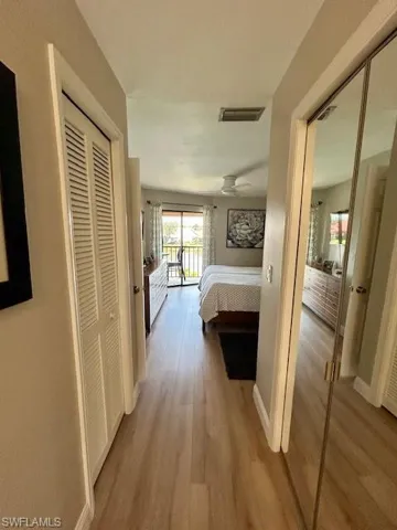 Hall with light wood-style flooring and baseboards