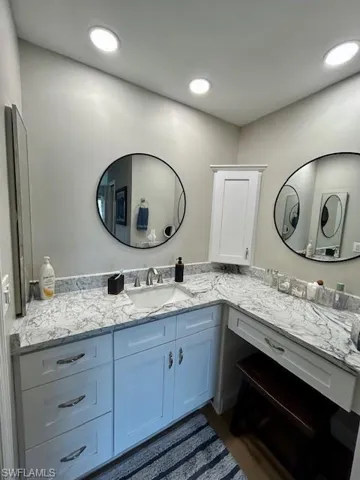 Bathroom with vanity and recessed lighting