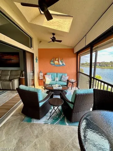 Lanai featuring an outdoor lounge area, vaulted ceiling, a ceiling fan, and a water view