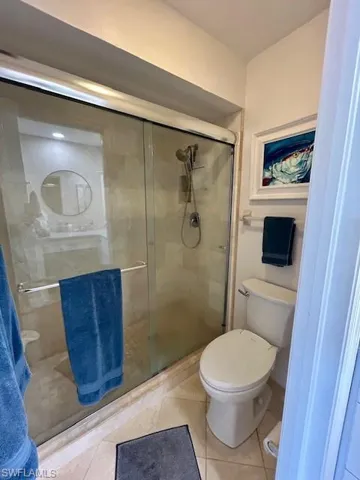Full bathroom with a stall shower and light tile patterned floors