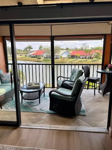 Balcony featuring an outdoor hangout area, a residential view, and a water view