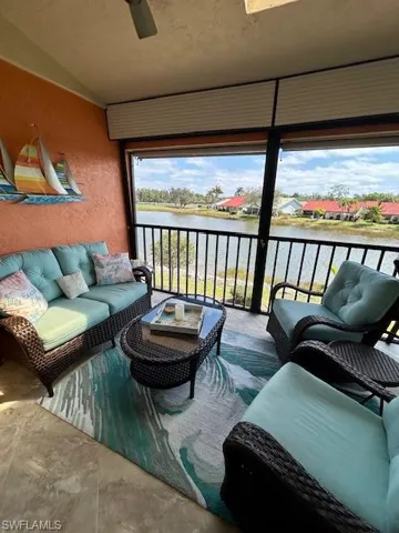 Lanai with outdoor lounge area, a ceiling fan, a water view, lofted ceiling, and a balcony