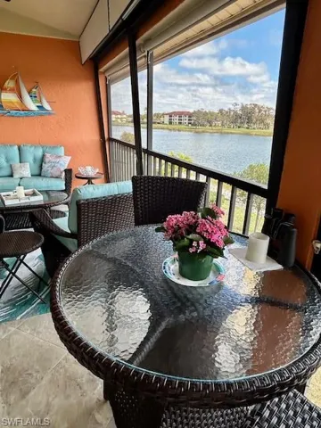 Lanai with a water view and outdoor seating