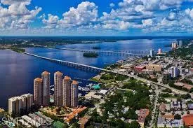 View of urban area featuring a large body of water and a notable bridge