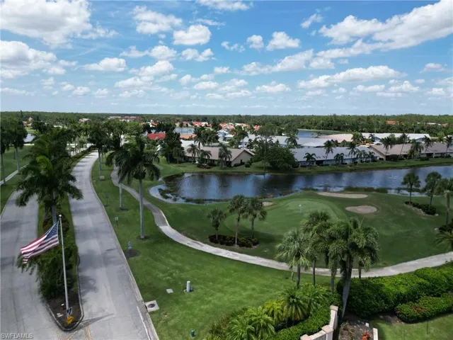 Aerial view of residential area with a large body of water and a golf course
