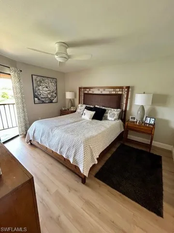 Bedroom with access to outside, light wood-style floors, and a ceiling fan