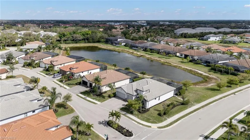 Aerial perspective of suburban area featuring a nearby body of water