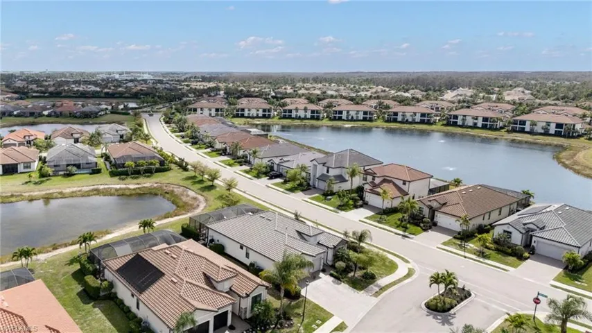 Aerial view of residential area featuring a nearby body of water