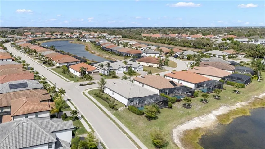Aerial overview of property's location with a nearby body of water and nearby suburban area