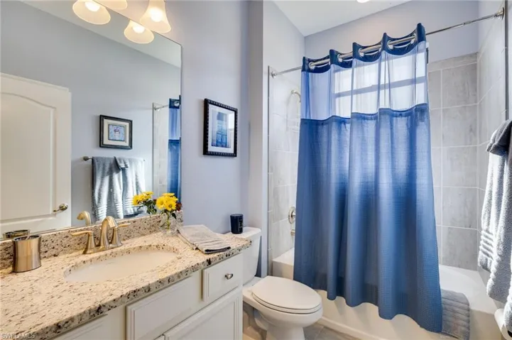 Bathroom featuring vanity and shower / bath combo with shower curtain
