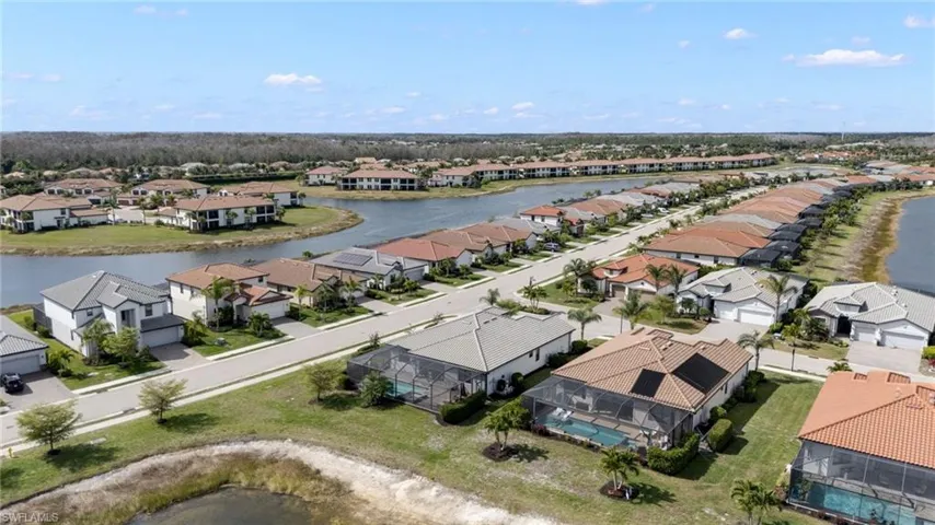 Aerial view of residential area featuring a large body of water
