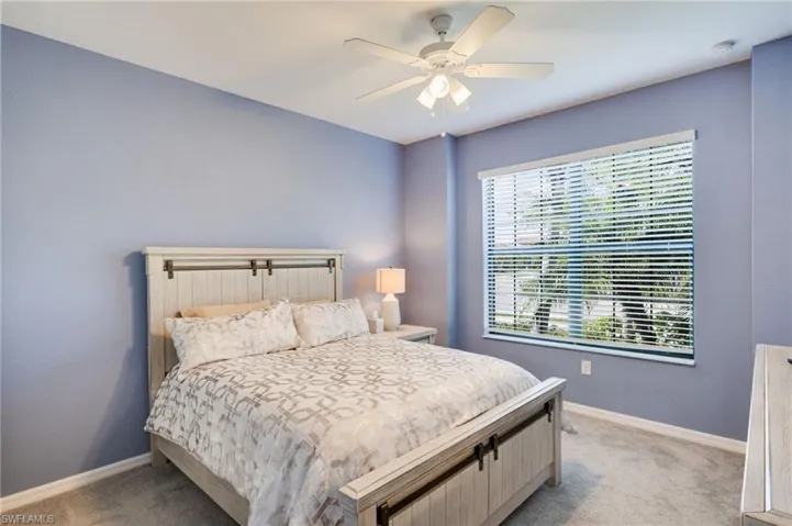 Bedroom with light carpet and ceiling fan