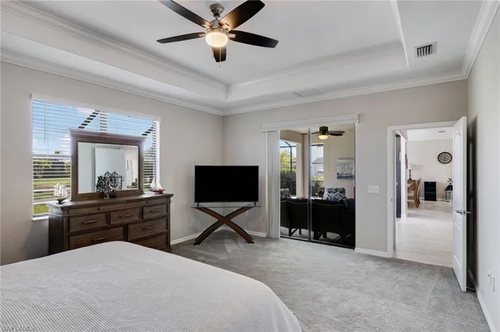 Bedroom featuring access to outside, carpet flooring, ceiling fan, and ornamental molding