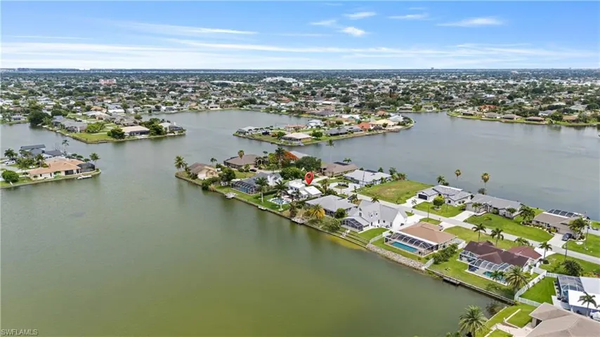 Aerial perspective showcasing a canal-front property amidst a network of waterways