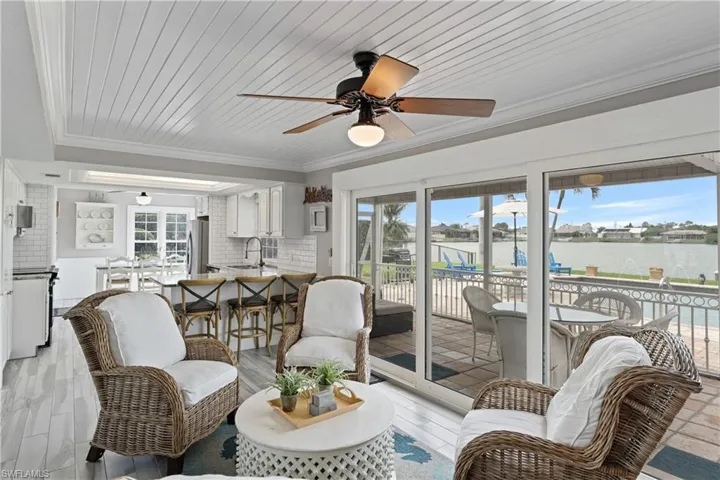 Open-concept living space featuring shiplap ceiling, wood-finish flooring, and a ceiling fan