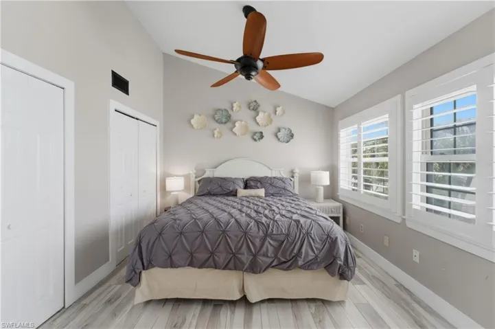 Vaulted ceiling room with wood-finish flooring