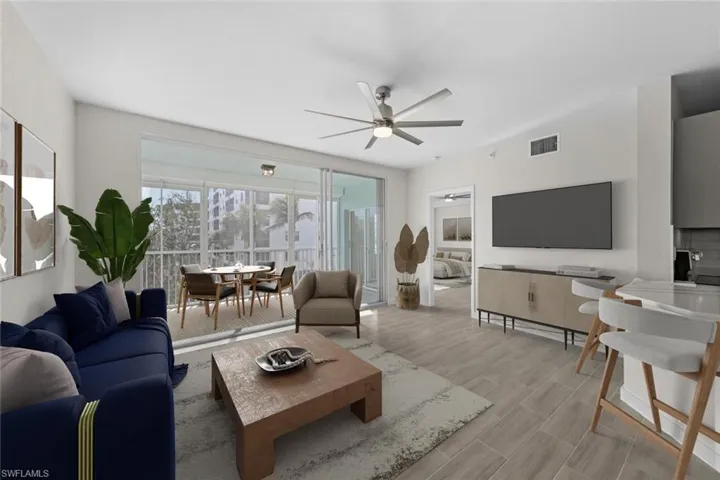 Living area with a ceiling fan and wood finished floors
