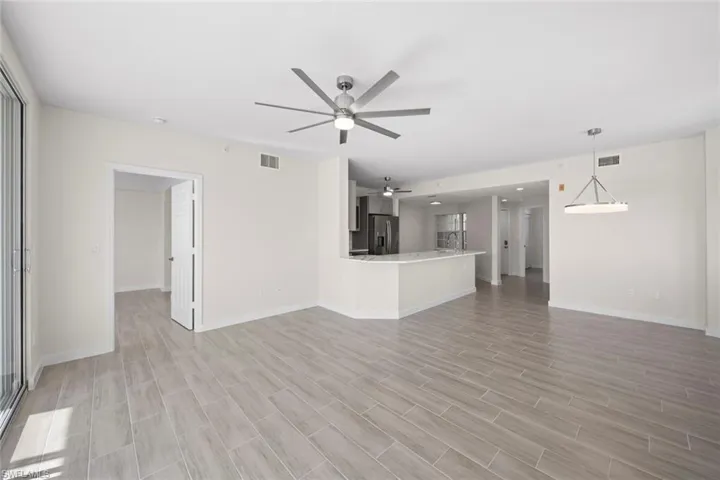 Unfurnished living room with a ceiling fan and light wood finished floors