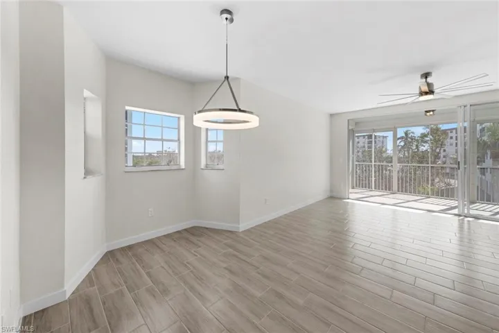 Unfurnished dining area featuring a ceiling fan and wood tiled floors