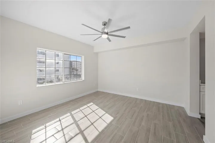 Spare room with wood tiled floors and a ceiling fan