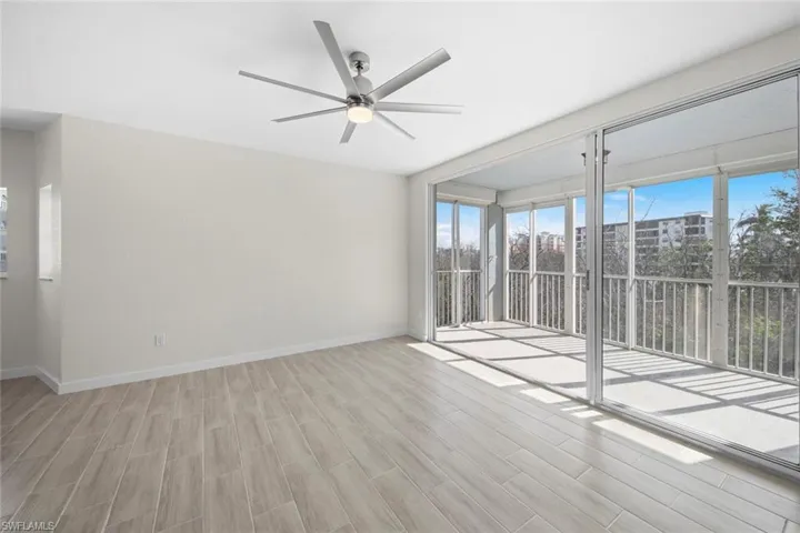 Empty room featuring light wood-type flooring and a ceiling fan