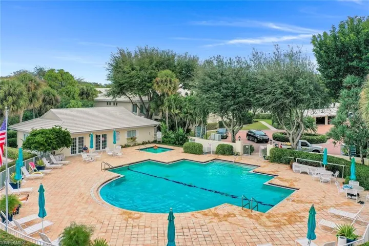Community pool with a patio area, a hot tub, and french doors