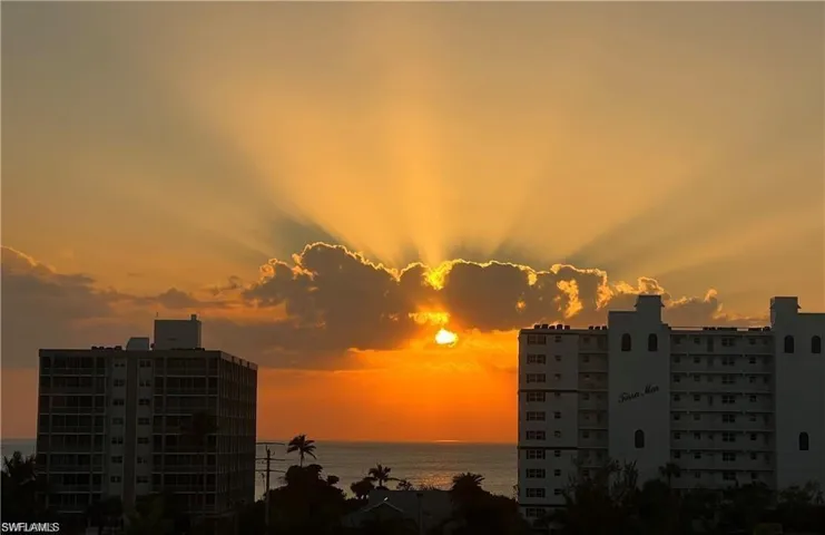 Property's view of beach at sunset.