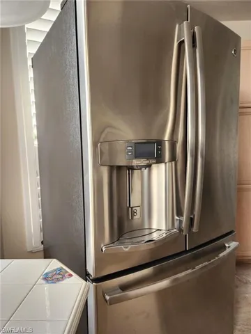 Interior details with stainless steel refrigerator with ice dispenser