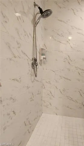 Room details featuring a tile shower