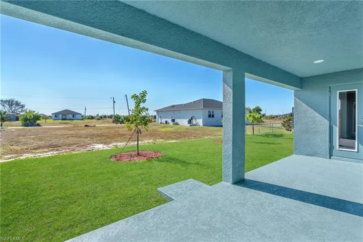 View of green lawn featuring a patio area
