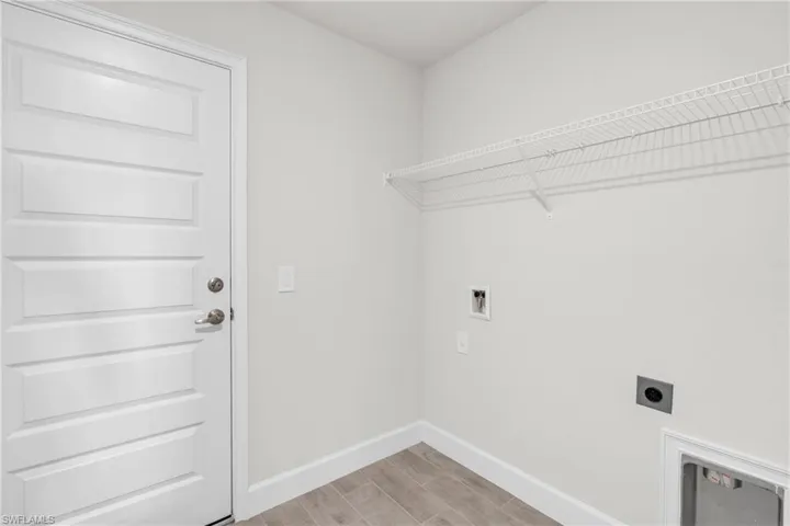 Laundry area with electric dryer hookup, wood tiled floors, and hookup for a washing machine