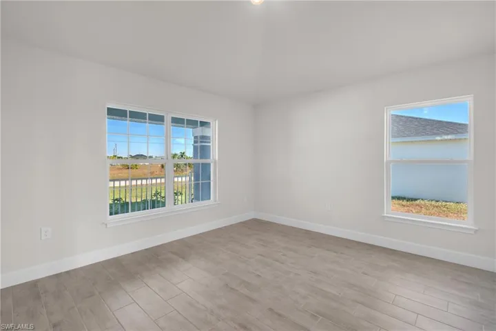 Unfurnished room with baseboards and light wood-style floors