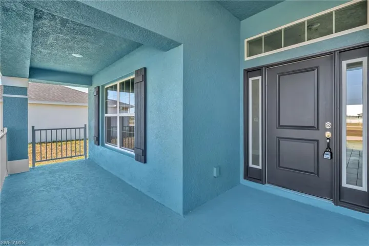Entrance to property with stucco siding