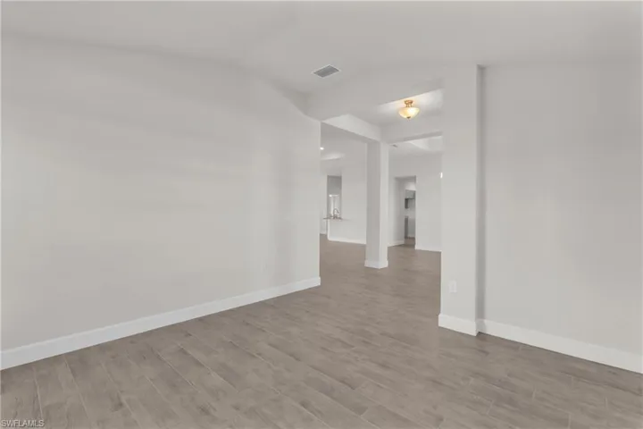 Unfurnished dining area featuring a chandelier and wood finish floors