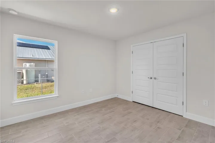 Unfurnished bedroom featuring a closet and wood tiled floors