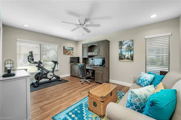 Office space with ceiling fan, light wood-type flooring, and a wealth of natural light